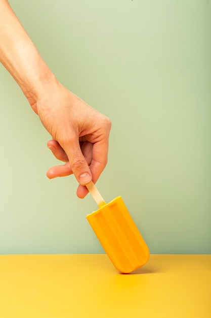 Hand holding ice cream pop stickle