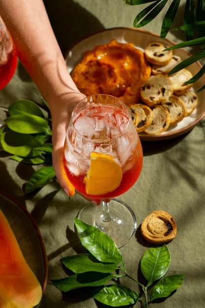 Free photo hand holding italian cocktail still life