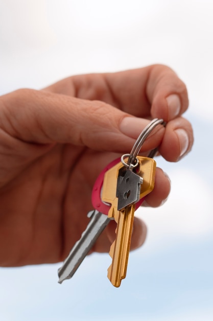 Hand holding keys outdoors