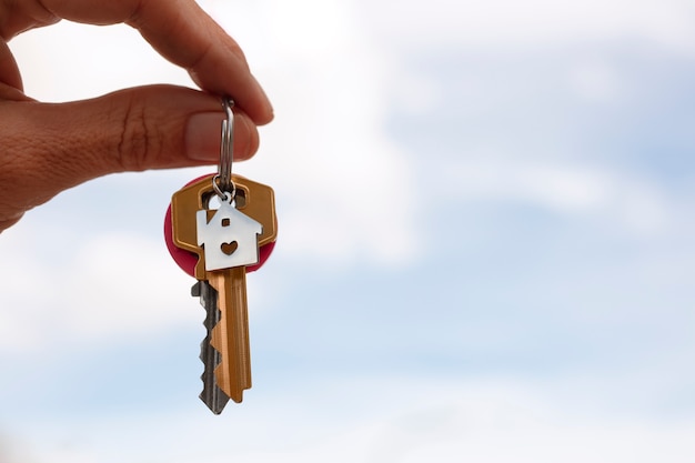 Hand holding keys outdoors