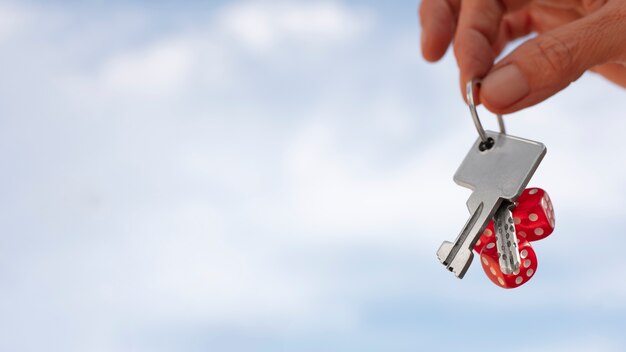 Hand holding keys outdoors