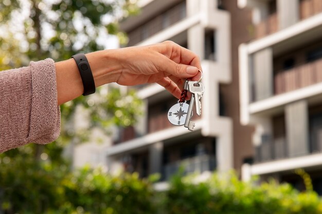 Hand holding keys outdoors