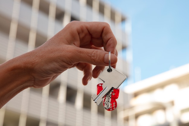 Hand holding keys outdoors