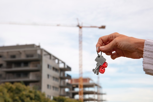 Free photo hand holding keys outdoors