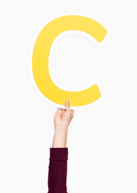 Free photo hand holding the letter c