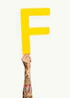 Free photo hand holding the letter f
