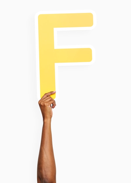 Free photo hand holding the letter f