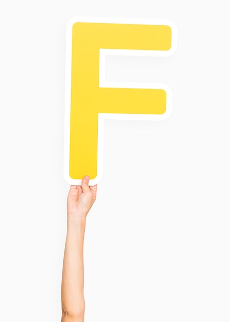 Hand holding the letter F