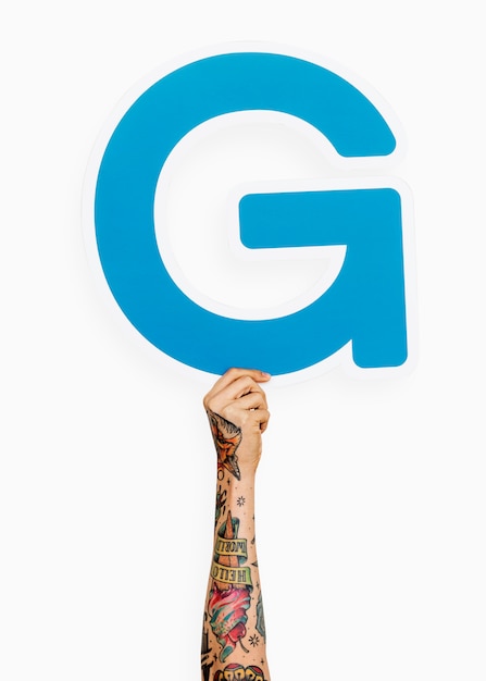 Free photo hand holding the letter g