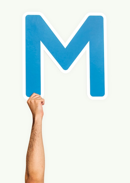 Free photo hand holding the letter m