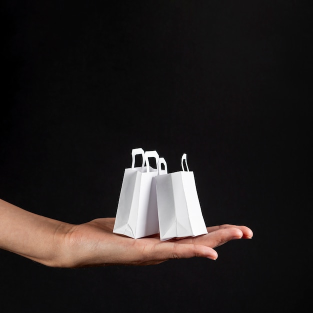 Hand holding little white bags