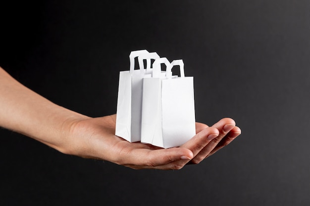 Hand holding little white bags