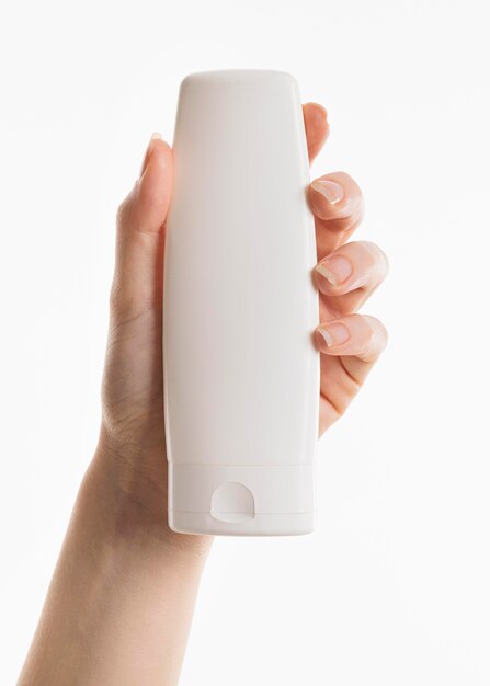 Hand holding lotion bottle