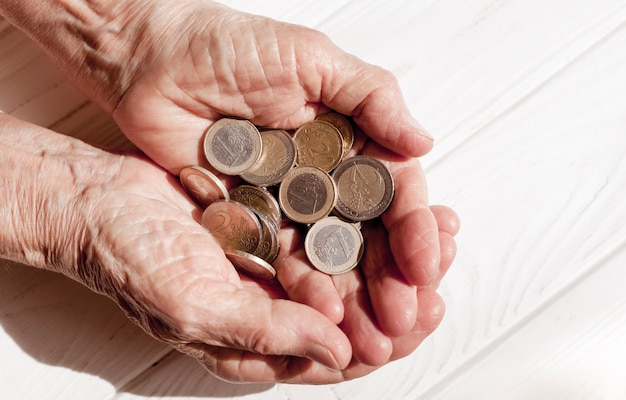 Hand holding lots of euro coins