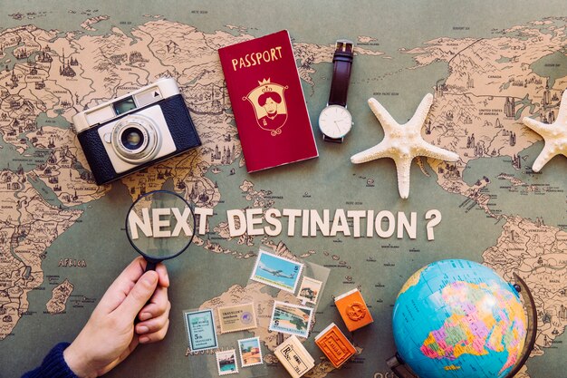 Hand holding magnifier over next destination writing