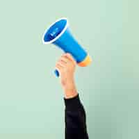 Free photo hand holding megaphone marketing announcement campaign