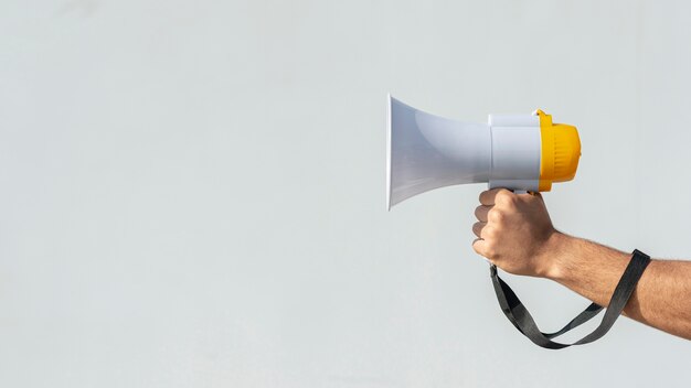 Hand holding megaphone for protest