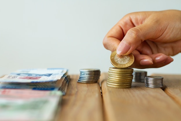 Hand holding mexican coin