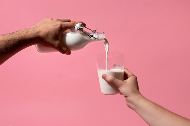 Hand holding milk bottle still life