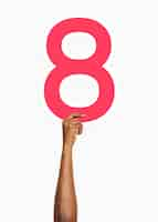 Free photo hand holding number eight sign