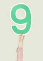 Free photo hand holding number nine sign