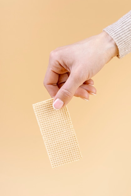 Free photo hand holding one piece of wafer