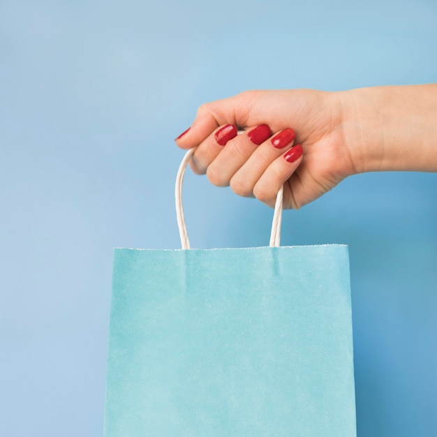 Hand holding paper bag