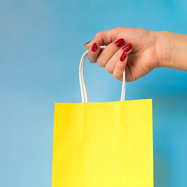 Hand holding paper bag