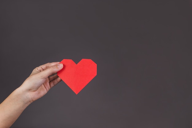 Hand holding a paper heart