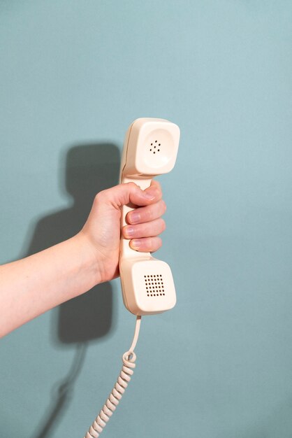hand holding phone with blue background