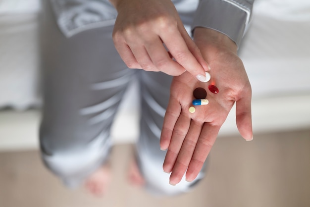 Hand holding pill close up