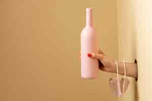 Free photo hand holding pink bottle close up