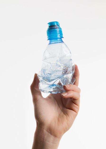 Free photo hand holding plastic bottle