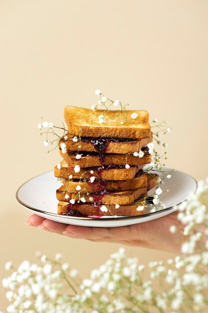 Hand holding plate with toast