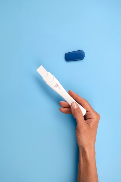 Free photo hand holding positive pregnancy test