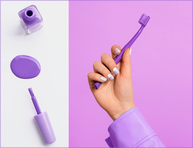 Hand holding purple toothbrush