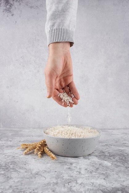 Hand holding rice zakat still life