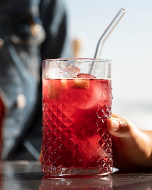 Hand holding sangria glass outdoors