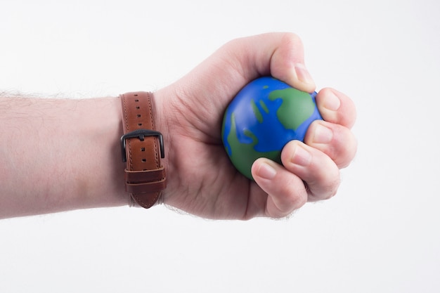 Hand holding a small globe
