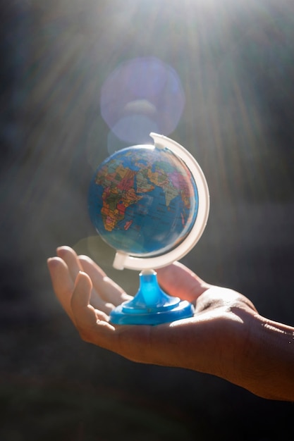 Hand holding small world globe 