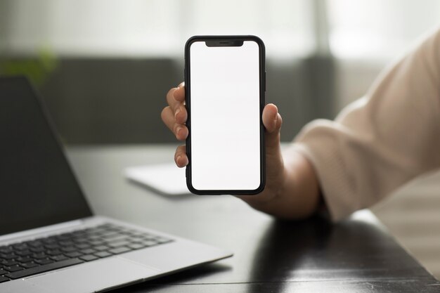 Hand holding smartphone close up