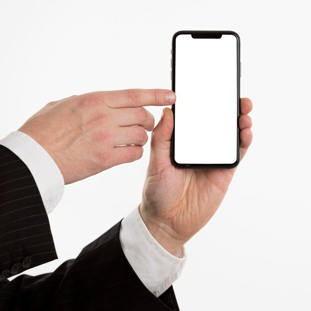 Hand holding smartphone and pointing at it