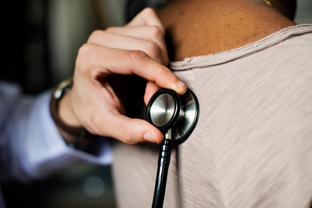 Hand holding stethoscope for check-up