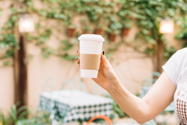 Hand holding take away coffee