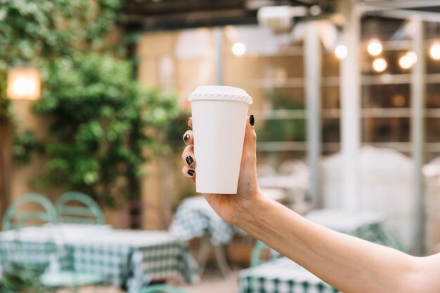 Hand holding take away coffee