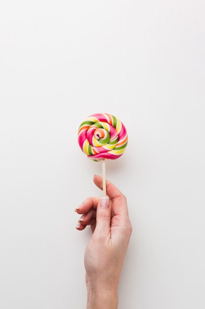 Hand holding a tasty lollipop