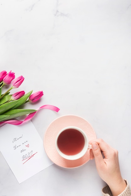 Free photo hand holding tea mug copy space