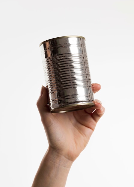 Hand holding tin can