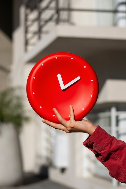 Hand holding wall clock still life