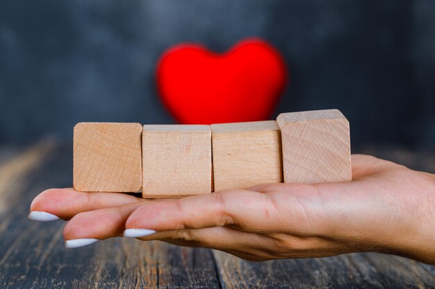 Hand holding wooden cubes